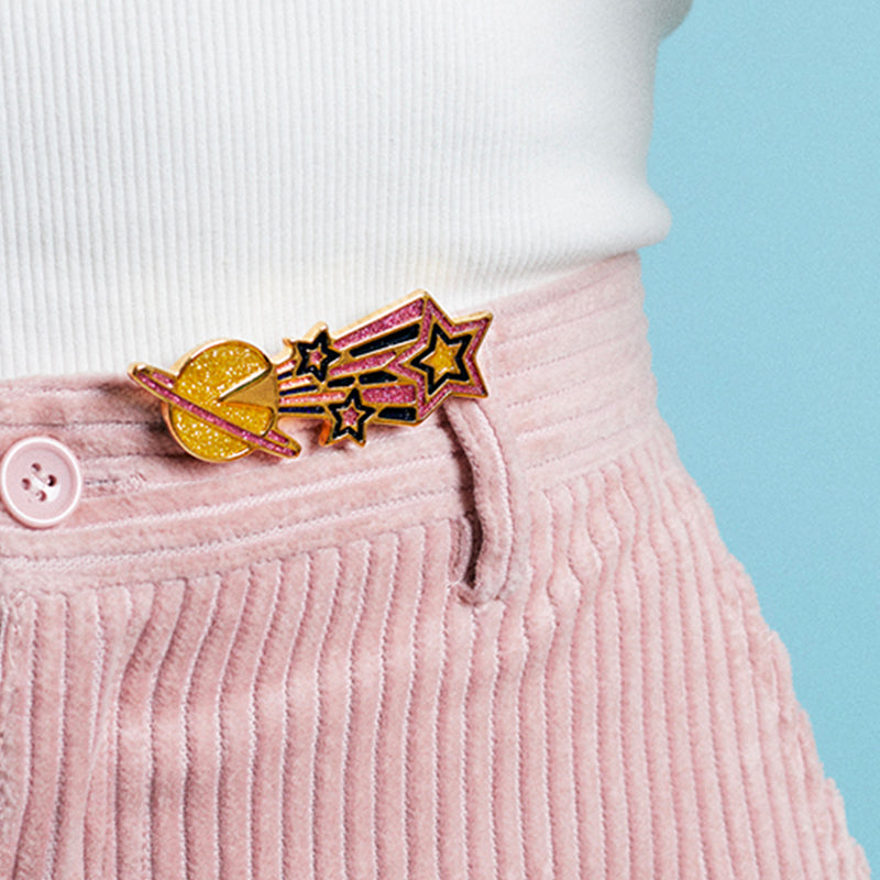 Jewel clip in the form of a glittering shooting star worn on a pink velvet trouser belt