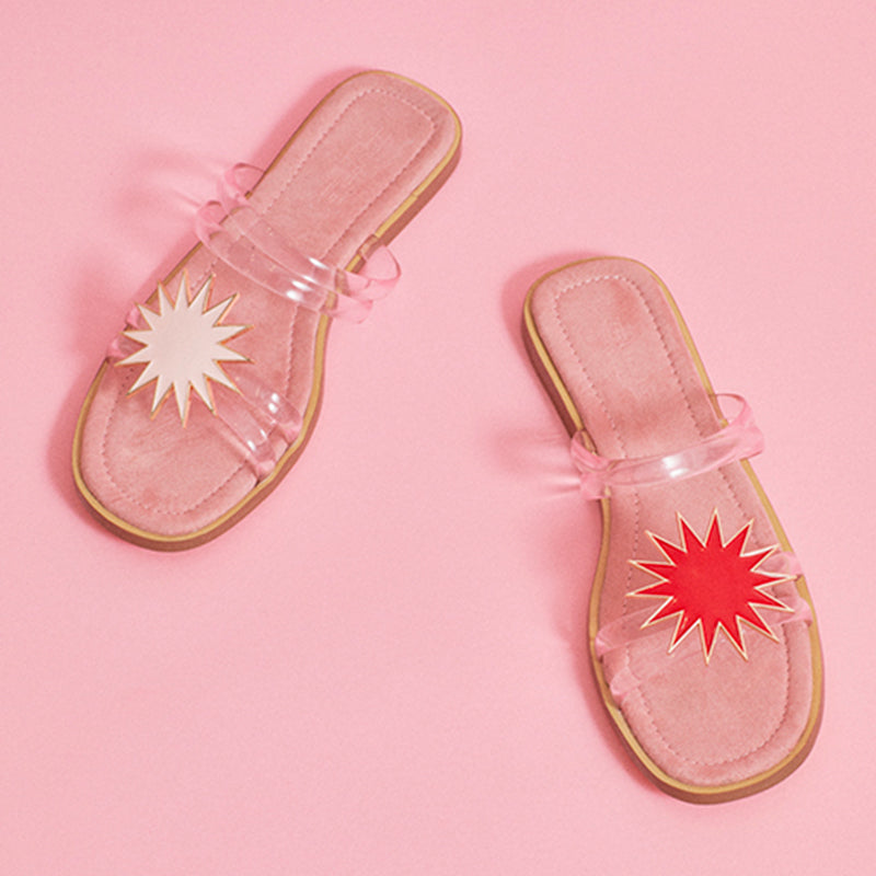 Pale pink star-shaped jewel clip worn over transparent sandals